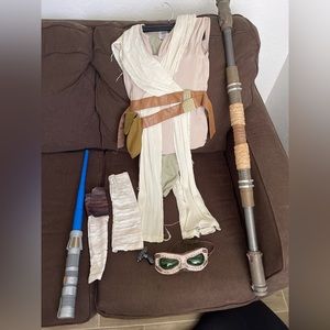 Disney store Rey costume with one light saber and Rey’s staff.